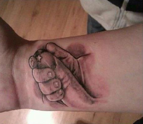 le tatouage d'une main qui tient un doit